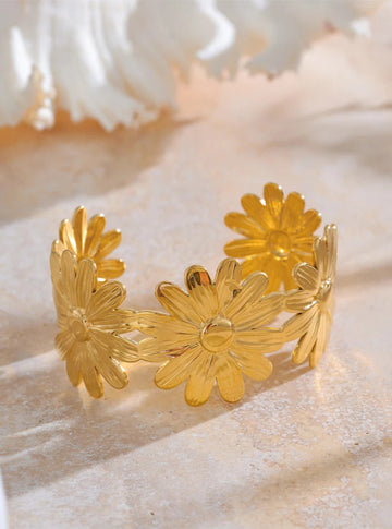 Gold floral bracelet on a light background