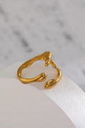 Gold ring on a white stone surface with a marble background
