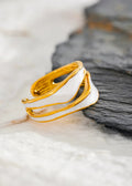 Gold and white ring on a textured surface