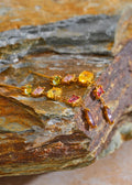 Bracelet with colorful gemstones on a textured stone surface