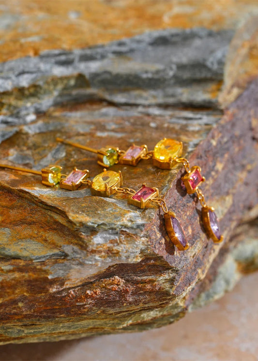 Bracelet with colorful gemstones on a textured stone surface