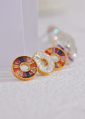Colorful circular earrings on a white background