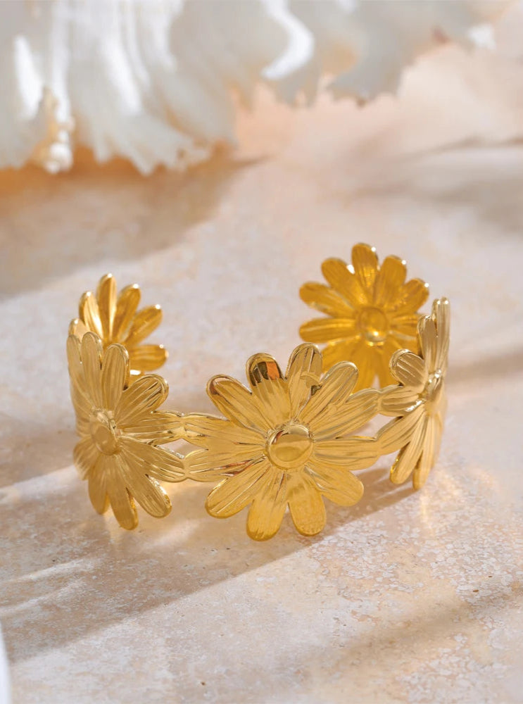 Gold floral bracelet on a light background