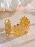 Gold floral bracelet on a light background