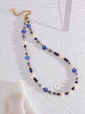 Necklace with blue and gray  turkish style evil eye beads on a white background