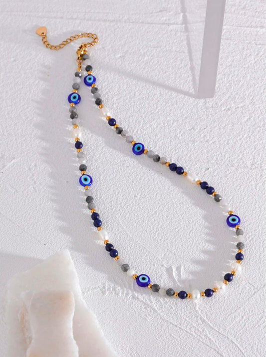 Necklace with blue and gray  turkish style evil eye beads on a white background