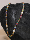 Multicolored beaded necklace on a dark stone surface